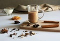 Traditional Indian masala tea with spices. Anise, star anise, cinnamon, pepper, milk. White background Royalty Free Stock Photo