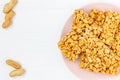 Traditional indian peanut chikki on plate on white background top view