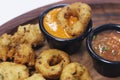 traditional indian snack food, crispy deep fried vada and chutneys in a serving plate