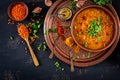 Traditional Indian soup lentils. Indian Dhal spicy curry in bowl, spices, herbs Royalty Free Stock Photo