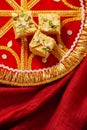 Traditional Indian sweets on a decorative red fabric Royalty Free Stock Photo