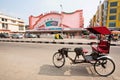 Traditional indian trishaw transport stands past the famous Raj Mandir movie theater