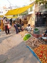 Traditional Indian vegetable market people purchasing vegetables from green grocer in Rajasthan Jaipur sanganer