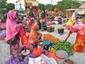 Traditional Indonesian marketplace with many women selling fish and produce. Muslim women doing activities at the local market