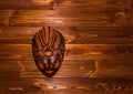 Traditional Indonesian mask in Bali stile on wooden background