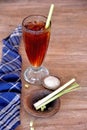 Traditional Indonesian sweet ice tea names Es Teh Sereh placed on the brown wooden table Royalty Free Stock Photo