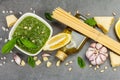 Traditional ingredients for the preparation of classic Italian pasta. Dry spaghetti, basil pesto Royalty Free Stock Photo