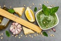 Traditional ingredients for the preparation of classic Italian pasta. Dry spaghetti, basil pesto Royalty Free Stock Photo