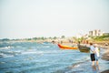 Traditional iranian colorful wooden motor boats on caspian sea shore in Bandar Anzali beach, north Iran, Gilan province