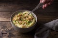 Traditional Irish dish colcannon, mashed potatoes with cabbage and green onions, on top of crispy fried cabbage topping with nuts