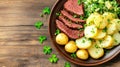 Traditional Irish meal featuring corned beef, cabbage, and potatoes served on a wooden table decorated with shamrocks Royalty Free Stock Photo