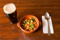 Traditional Irish Stew with a pint of stout beer and a spoon Royalty Free Stock Photo