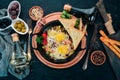 Traditional Israeli Cuisine dishes Shakshuka. Eggs with bacon and mushrooms. On a wooden background. Royalty Free Stock Photo