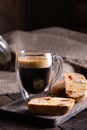 Traditional Italian almond biscuits biscotti served on a wooden board with a cup of aromatic coffee Royalty Free Stock Photo