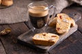 Traditional Italian almond biscuits biscotti served on a wooden board with a cup of aromatic coffee Royalty Free Stock Photo