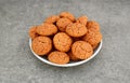 Traditional Italian almond cookies amaretti in a white plate on a gray background.Famous amarettini cookie biscuits. Royalty Free Stock Photo