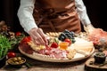 Traditional italian antipasto. Assorted cheeses, grapes, olives, prosciutto, rosemary. Delicious appetiser Italian prosciutto and Royalty Free Stock Photo