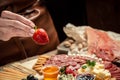 Traditional italian antipasto. Assorted cheeses, grapes, olives, prosciutto, rosemary. Delicious appetiser Italian prosciutto and Royalty Free Stock Photo