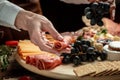 Traditional italian antipasto. Assorted cheeses, grapes, olives, prosciutto, rosemary. Delicious appetiser Italian prosciutto and Royalty Free Stock Photo