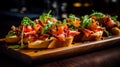 Traditional Italian antipasto bruschetta appetizer with meat, fish, greens and balsamic vinegar. Bruschetta with beef, onion,