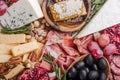 Traditional italian antipasto plate. Assorted cheeses on wooden cutting board. Brie cheese, cheddar slices, gogonzola, walnuts Royalty Free Stock Photo