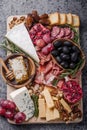 Traditional italian antipasto plate. Assorted cheeses on wooden cutting board. Brie cheese, cheddar slices, gogonzola, walnuts Royalty Free Stock Photo