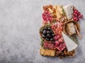 Traditional italian antipasto plate. Assorted cheeses on wooden cutting board. Brie cheese, cheddar slices, gogonzola, walnuts gra Royalty Free Stock Photo