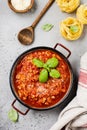 Traditional italian Bolognese sauce in saucepot an old dark wooden background. Royalty Free Stock Photo