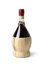 Traditional Italian bottle with Chianti wine close up on white background