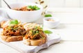 Traditional Italian Caponata and toast on a wooden white table. Royalty Free Stock Photo