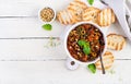 Traditional Italian Caponata and toast on a wooden white table.