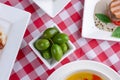 Traditional Italian cuisine, Italian concept. Green olives in a small white bowl. Royalty Free Stock Photo