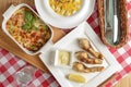 Traditional Italian cuisine, lasagna made with minced beef, pumpkin soup with seeds and cheese and fried fish. Top view. Royalty Free Stock Photo