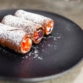 Traditional italian dessert cannoli on black plate. Royalty Free Stock Photo