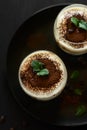 Traditional Italian dessert tiramisu decorated cocoa, coffee beans and mint leaves Royalty Free Stock Photo