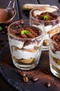 Traditional Italian dessert tiramisu served in a glass on a dark background. Royalty Free Stock Photo