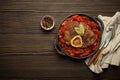 Traditional Italian dish Ossobuco all Milanese made with cut veal shank meat with vegetable tomato sauce served in black Royalty Free Stock Photo