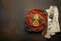 Traditional Italian dish Ossobuco all Milanese made with cut veal shank meat with vegetable tomato sauce served in black Royalty Free Stock Photo