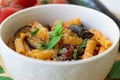 Traditional italian dish: pasta alla norma with tomatoes, eggplant, garlic, basil and ricotta cheese Royalty Free Stock Photo