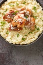 Traditional Italian dish Risotto with chicken, garlic, parmesan cheese and herbs closeup on the plate. Vertical top view