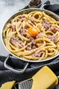 Traditional italian dish spaghetti carbonara with bacon in a cream sauce in a skillet. Gray background. Top view Royalty Free Stock Photo