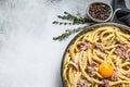 Traditional italian dish spaghetti carbonara with bacon in a cream sauce in a skillet. Gray background. Top view. Copy space Royalty Free Stock Photo