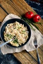 Traditional italian dish spaghetti carbonara with bacon in a cream sauce in a skillet over dark wooden background.Top Royalty Free Stock Photo