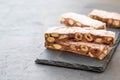 Traditional italian festive chocolate torrone or nougat with nuts close up. Copy space. Royalty Free Stock Photo