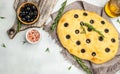 Traditional Italian focaccia bread with olives, rosemary on a light background. Restaurant menu, dieting, cookbook recipe top view Royalty Free Stock Photo
