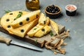 Traditional Italian focaccia bread with olives, rosemary on a light background. Restaurant menu, dieting, cookbook recipe top view