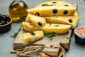 Traditional Italian focaccia bread with olives, rosemary on a light background. Restaurant menu, dieting, cookbook recipe top view