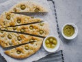 Traditional Italian focaccia bread with olives, rosemary, salt and olive oil. Homemade focaccia. Royalty Free Stock Photo