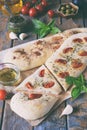 Traditional Italian Focaccia with tomatoes, basil, garlic and sumach. Homemade pastry. Flat bread. Organic flatbread. Rustic style Royalty Free Stock Photo