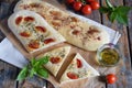 Traditional Italian Focaccia with tomatoes, basil, garlic and sumach. Homemade pastry. Flat bread. Organic flatbread. Rustic style Royalty Free Stock Photo